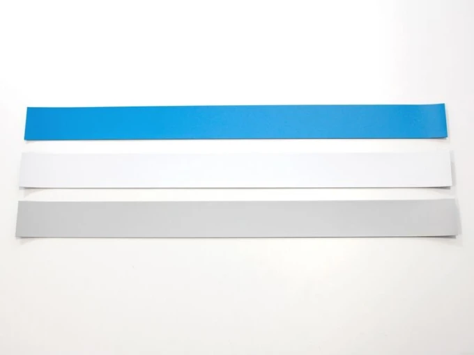 Self-adhesive magnetic strip for magnets, 60 cm - various colors - Graphic design. Three rectangular strips in color.