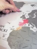 Premium scratch-off world map - Graphic design featuring continents in various colors with clear country borders.