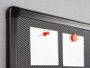 Magnetic pinboard with graphic design. Two white sheets attached to the mesh with magnets.