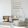Wall template with the saying: There is no path to happiness 1963 - Living room arrangement. Light-colored walls, minimalist style.