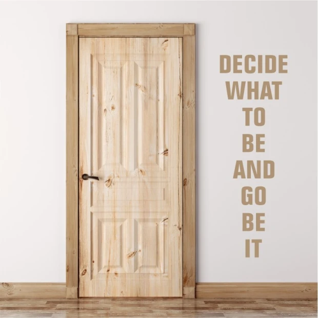 Wall template with quote: Decide what to be 1951 - Hallway arrangement. Light-colored wall, wooden door.