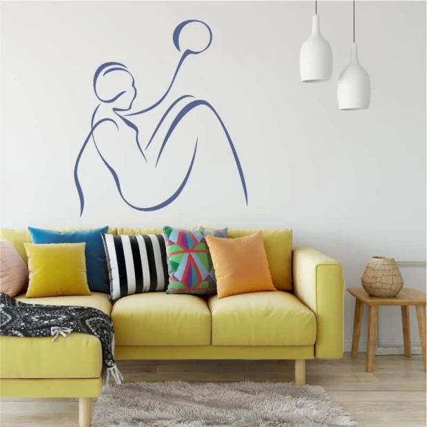 Wall template of a woman with a ball 2036 - Living room setup. Light walls, colorful cushions on the sofa.