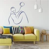 Wall template of a woman with a ball 2036 - Living room setup. Light walls, colorful cushions on the sofa.