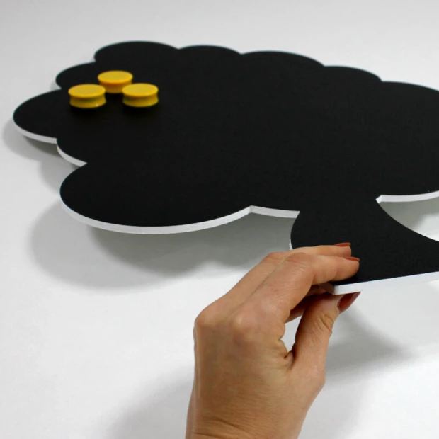 Magnetic chalkboard for kids in tree shape with a black surface and yellow magnets.