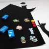 Magnetic chalkboard for kids with a cat house design. Features colorful stickers on a black background.