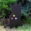 Magnetic chalkboard for kids featuring a black cat with colorful yellow and blue circles.