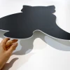 Magnetic chalkboard for kids in the shape of a rounded black cat design.