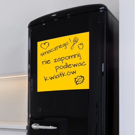 Dry-erase magnet for the fridge - Kitchen setup with light walls, modern furniture, and a black fridge.