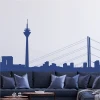 City skyline wall sticker 2282 - Living room setup with light-colored walls and a dark sofa with cushions.