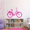 Wall sticker of a bicycle for a child\'s room. Bright walls with colorful dots.