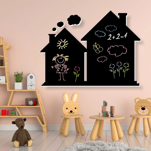 Chalkboard for kids\' room with houses design. Light-colored walls and natural wood furniture.