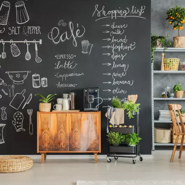 Custom chalkboard - Kitchen decor. Dark walls, wooden furniture, and plants.