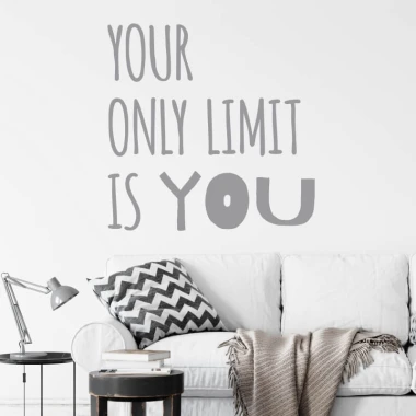 Wall sticker with the phrase "Your only limit is you" - Living room decor. Light-colored walls, light sofa.