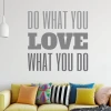 Painting template with the phrase "Do what you love" - Living room arrangement. Light-colored walls, sofa with assorted cushions.