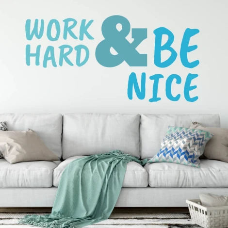 Painting template with the phrase "Work hard and be nice" - Living room arrangement. Light walls, sofa with assorted cushions.