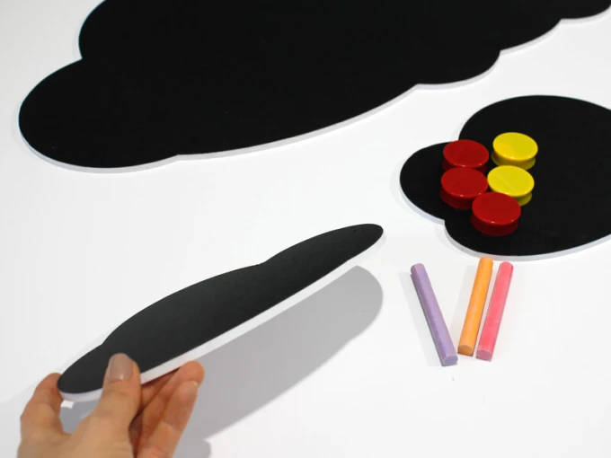 Magnetic chalkboard for kids with cloud design, featuring a black background and colorful magnets.