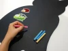 Magnetic chalkboard for kids in cat shape with colorful insect stickers.