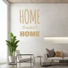 Home sweet home wall sticker 2432 - Living room decor with light-colored walls and a potted plant next to furniture.