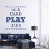 Wall sticker "Work hard play hard" 2429 - Decor in a bright living room with a dark sofa and lamp.