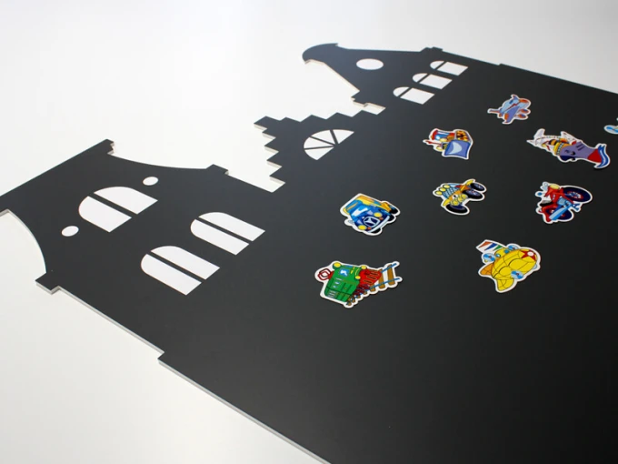 Chalkboard magnetic board houses 246 - Graphic design with a black background, cut-out house shapes, and colorful stickers.