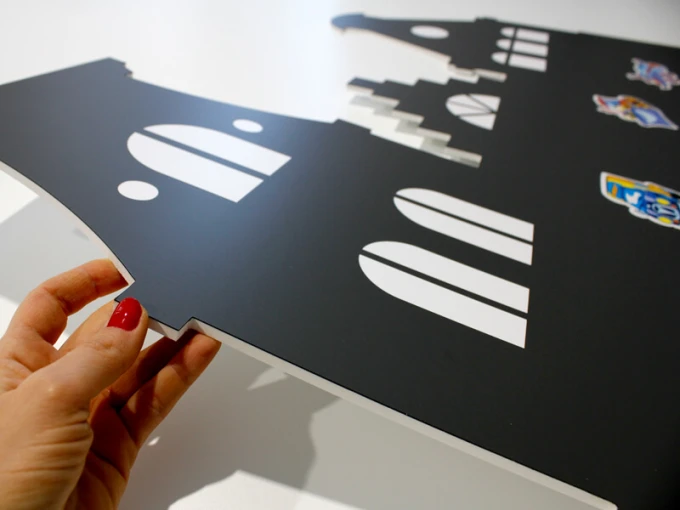 Chalkboard magnetic board houses 246 - Black board with white windows and doors shaped like houses.
