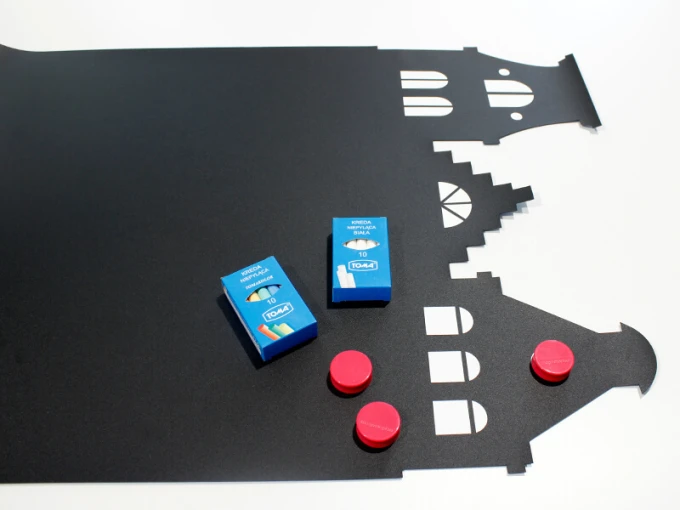 Chalkboard magnetic board with house shapes and colorful chalks, black design.
