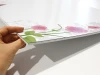 Magnetic whiteboard with floral design in shades of pink and green.