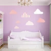 Colorful cloud wall stickers set 2441 - Perfect for a child\'s room with purple walls and white furniture.