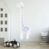 Giraffe growth chart sticker for kids\' room. Light-colored walls, minimalist decor.