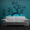 Elegant tree sticker 0772 in a modern living room with a blue wall, adding style and harmony.