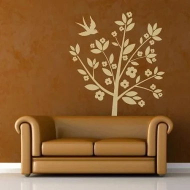 Bird tree sticker 1105 in warm shades against a brown wall, perfect for a cozy living room.