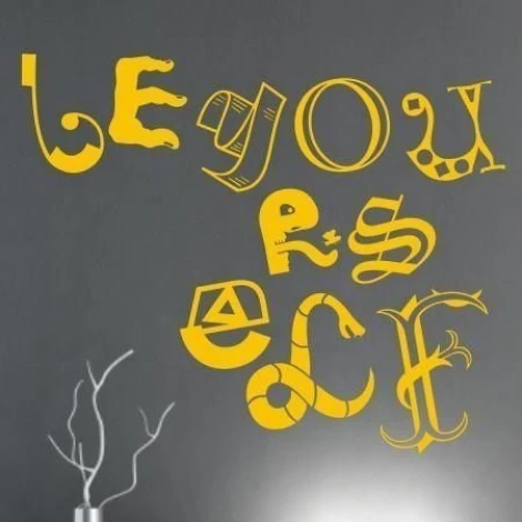 Vibrant "Be yourself" quote in energetic yellow, perfect for a modern interior.