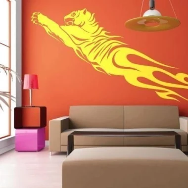 Energetic yellow tiger sticker adds a dynamic touch to a modern living room with orange accents.