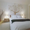 Elegant tree in warm tones on the wall of a cozy bedroom, adding charm and harmony.