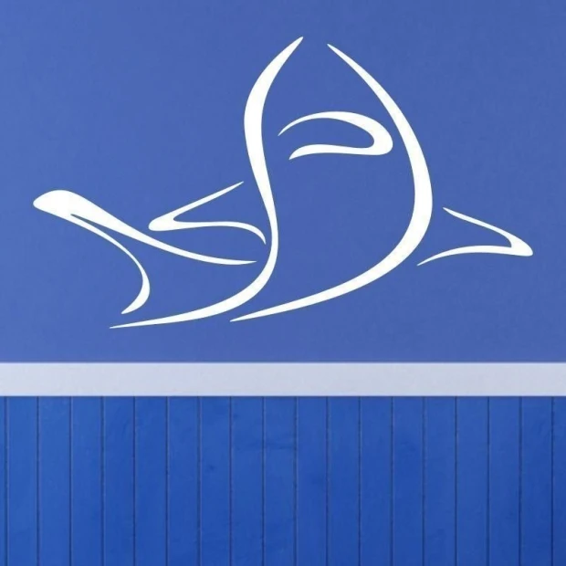 Stylish white shark sticker, perfect for a child\'s room, against a blue wall.