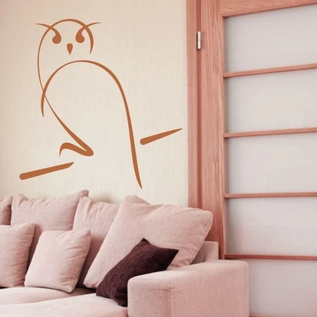 Stylish owl sticker 1265 in warm brown tones, decorating a cozy living room with light furniture.