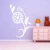 Delicate floral sticker 0976 on a purple wall in a cozy children\'s room, adding charm.