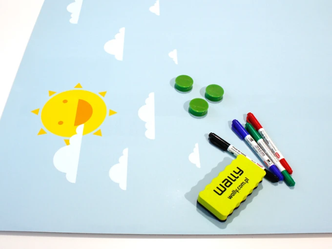 Dry-erase magnetic board for kids featuring sun and clouds design on a blue background with yellow accents.