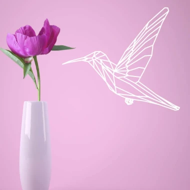 Hummingbird wall template 2476 - Living room setup with a light-colored wall and a vase with flowers nearby.