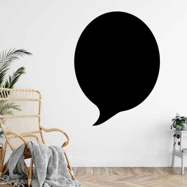 Chalkboard magnetic board in a room with light walls, wooden floor, and potted plants.