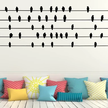 Bird wall template 2484 - Living room arrangement with light-colored walls and cushions in various patterns and colors.