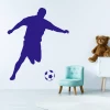 Wall sticker for kids featuring a soccer player 2486 - Decor in a bright children\'s room with a blue chair.