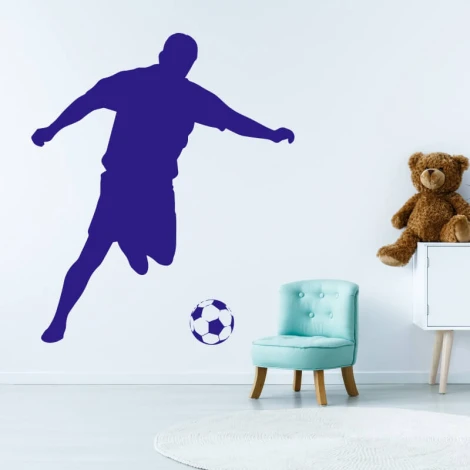 Wall sticker for kids featuring a soccer player 2486 - Decor in a bright children\'s room with a blue chair.