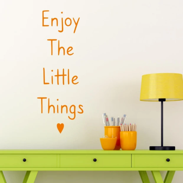Wall sticker "Enjoy the little things" 2499 - Room decor with light-colored wall, green table, and yellow lamp.