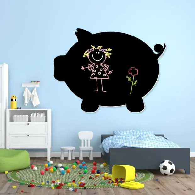 Chalkboard magnetic board for kids, pig design - Styled in a bright children\'s room with light walls and white furniture.