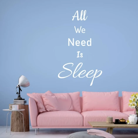 Wall sticker "All we need is sleep" 2500 - Living room decor. Light-colored wall, pink sofa with cushions.
