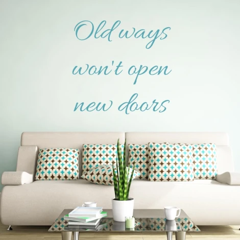 Wall sticker "Old ways won\'t open new doors" 2504 - Living room decor. Light-colored walls, sofa with cushions.