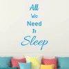 Wall template "All we need is sleep" 2500 - Living room decor. Light-colored walls, pillows in various patterns.