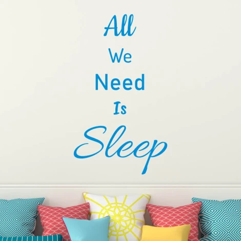 Wall template "All we need is sleep" 2500 - Living room decor. Light-colored walls, pillows in various patterns.