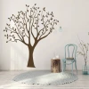 Painting template tree 2522 - Living room arrangement. Light-colored walls, wooden floor, minimalist furniture.